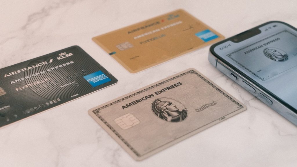three american express cards on a table