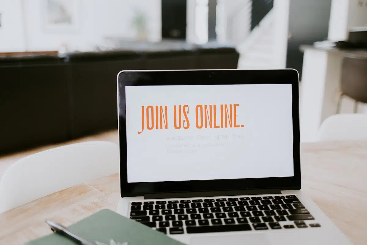 Laptop with on the screen saying 'Join Us Online'