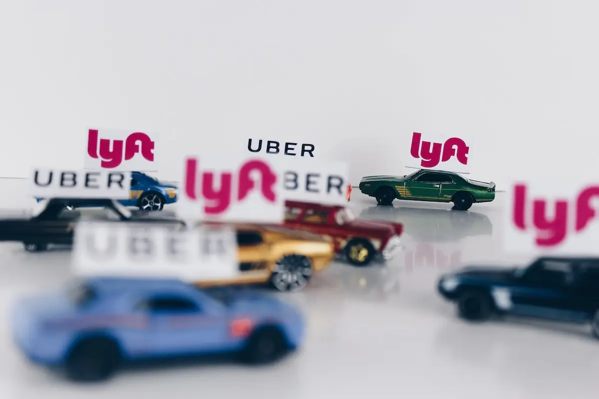 toy cars with uber and lyft stickers on top