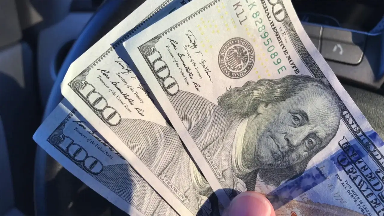 Three $100 bills