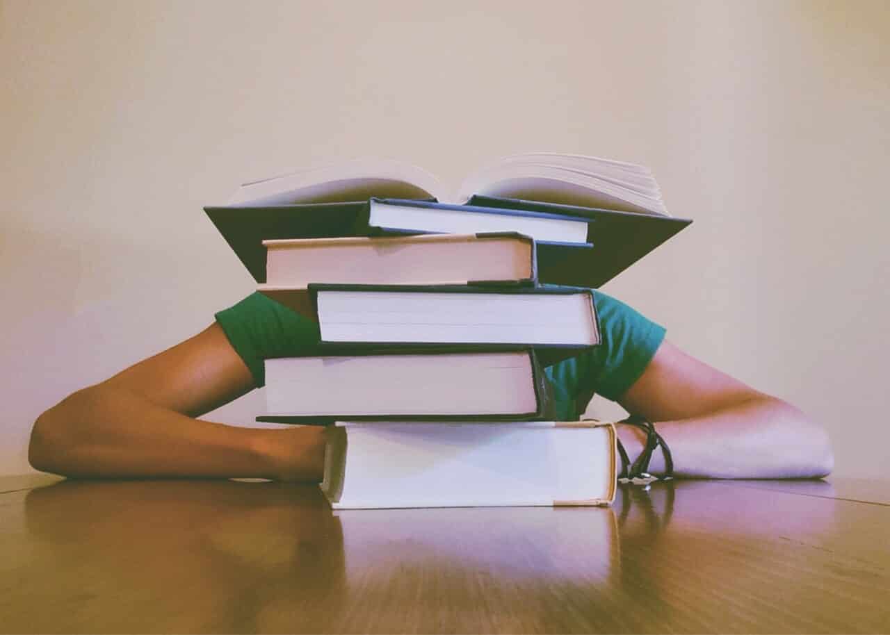 A woman with books on her desk