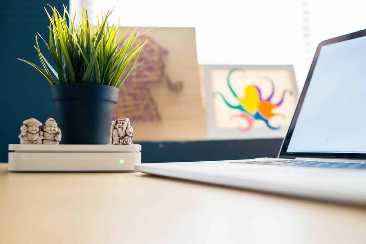 A desk with a laptop on top of it