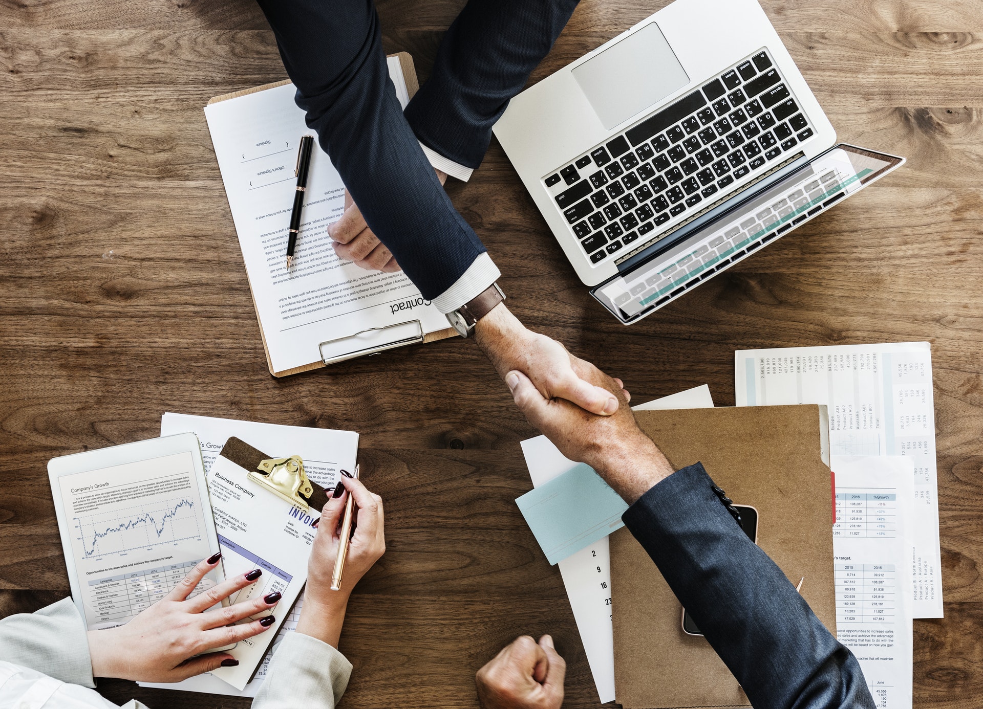 A table where two men are shaking hands