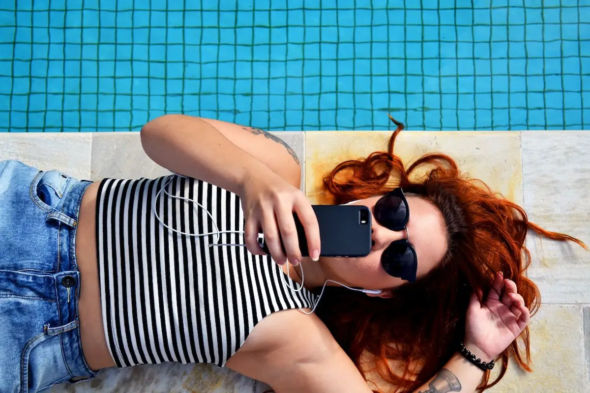 woman on ground on her phone searching for an app bonus