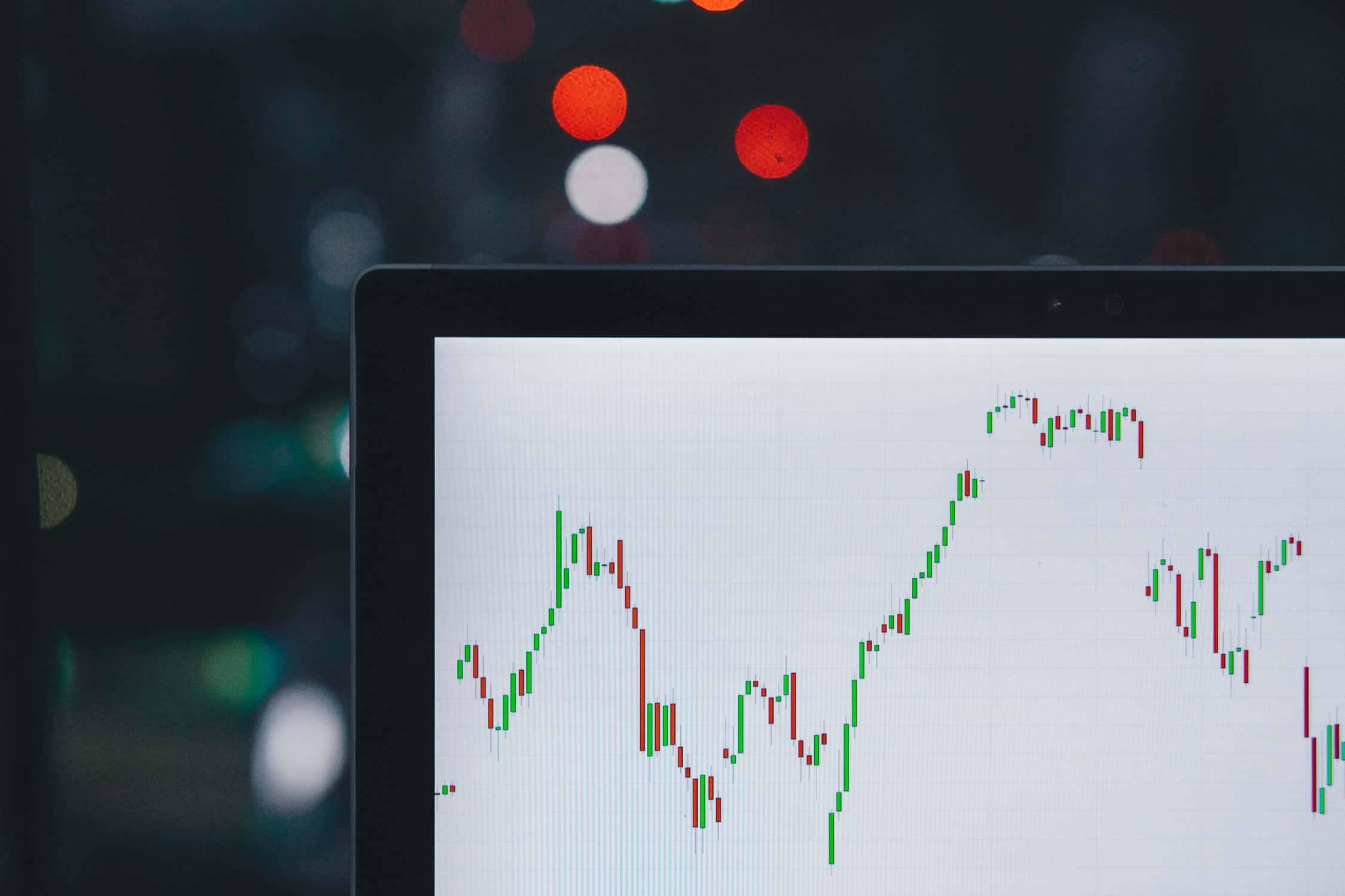 Laptop with stock market candle stocks on it